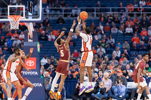 Elijah Moore scored 11 points on 3-of-3 shooting from beyond the arc to help Syracuse past Boston College in triple overtime.